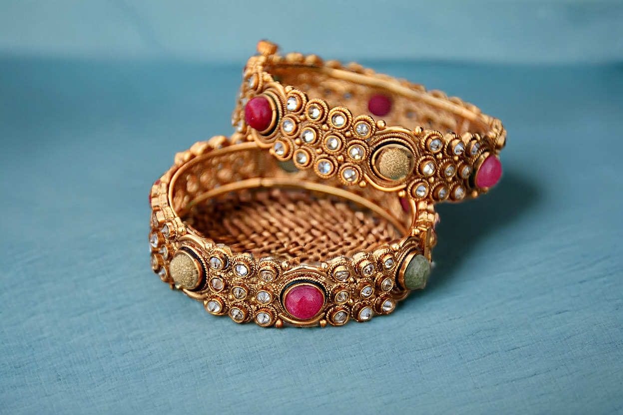 Create a stunning, professional photograph of a bracelet on a blue fabric surface